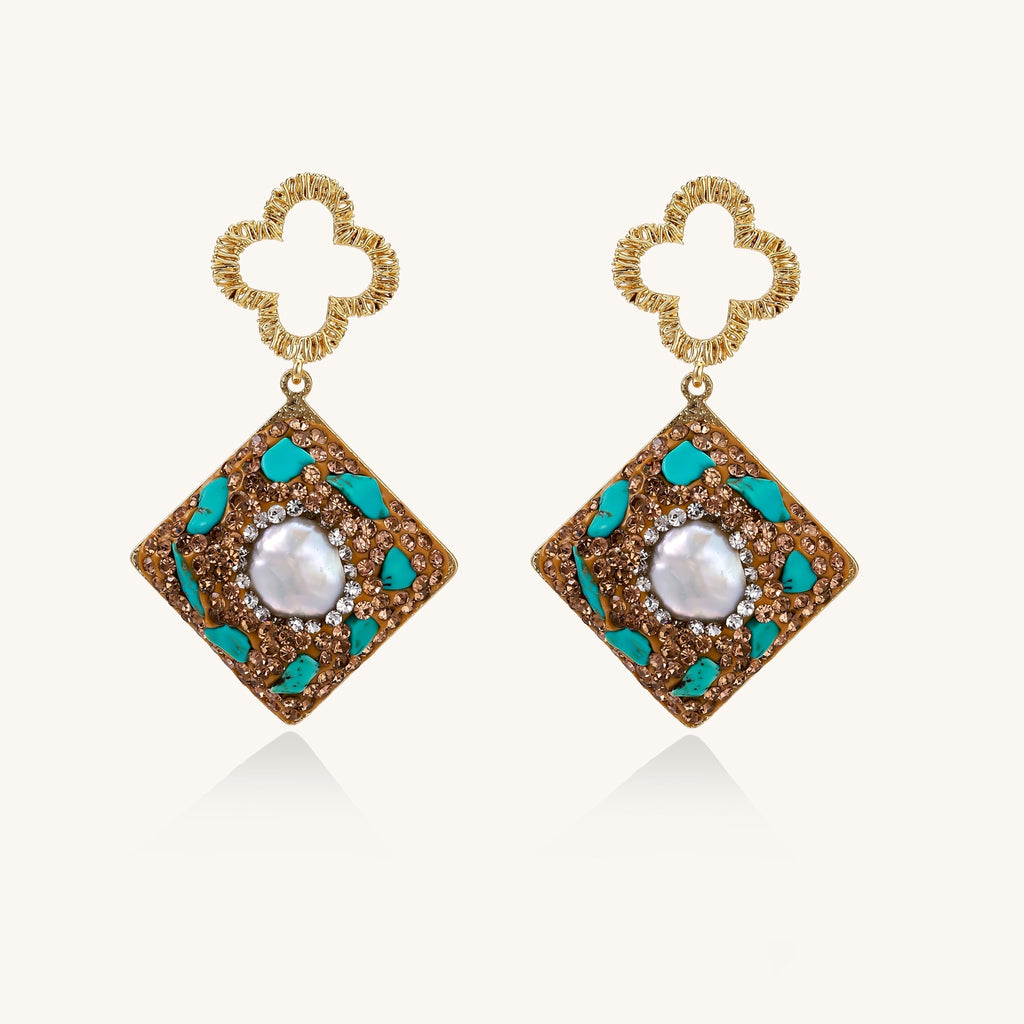 Gold quatrefoil stud earrings with ornate square pendants featuring turquoise stones and freshwater pearls