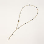 Long gold-plated necklace with alternating white and gray freshwater pearls spaced along delicate chain segments