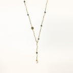 Long gold-plated necklace with alternating white and gray freshwater pearls spaced along delicate chain segments