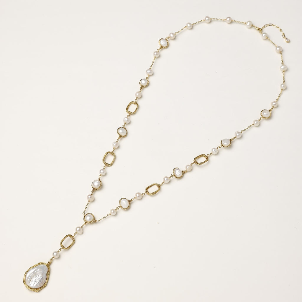 Y-shaped gold-plated necklace with freshwater pearls and geometric elements, featuring a baroque pearl pendant drop