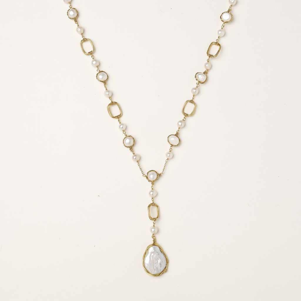 Y-shaped gold-plated necklace with freshwater pearls and geometric elements, featuring a baroque pearl pendant drop
