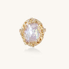 Ornate gold-plated ring with large baroque pearl in decorative vine-like setting with small crystal accents