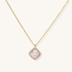 Gold-plated necklace with cushion-shaped pendant featuring a freshwater pearl surrounded by crystal halo on white background.