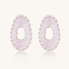 Oval lavender enamel earrings with gold studs around perimeter and cutout centers on white background
