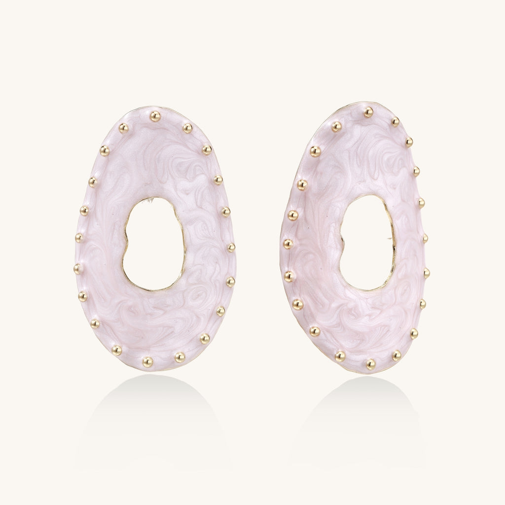 Oval lavender enamel earrings with gold studs around perimeter and cutout centers on white background