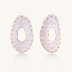 Oval lavender enamel earrings with gold studs around perimeter and cutout centers on white background