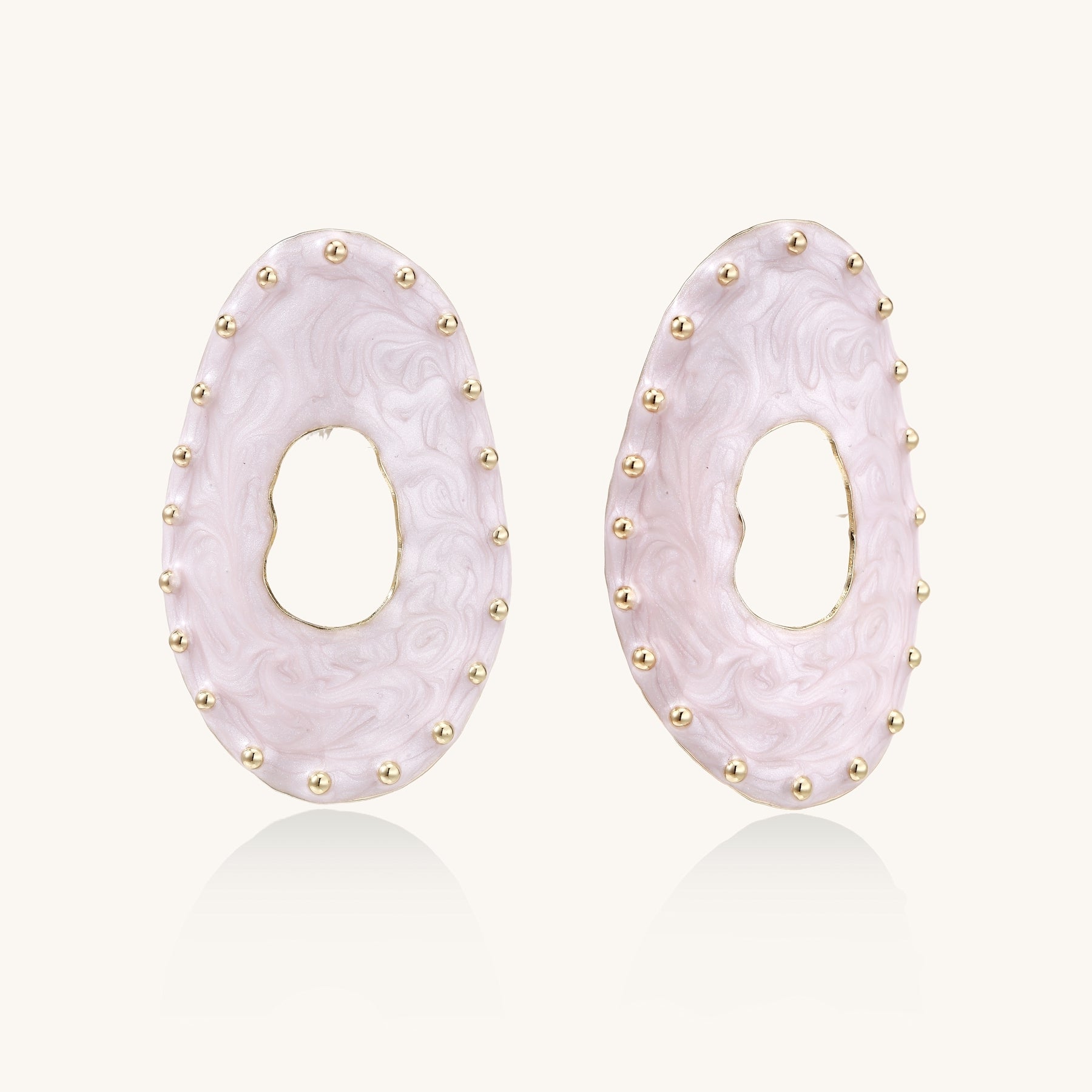 Oval lavender enamel earrings with gold studs around perimeter and cutout centers on white background