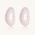 Oval lavender enamel earrings with gold studs around perimeter and cutout centers on white background