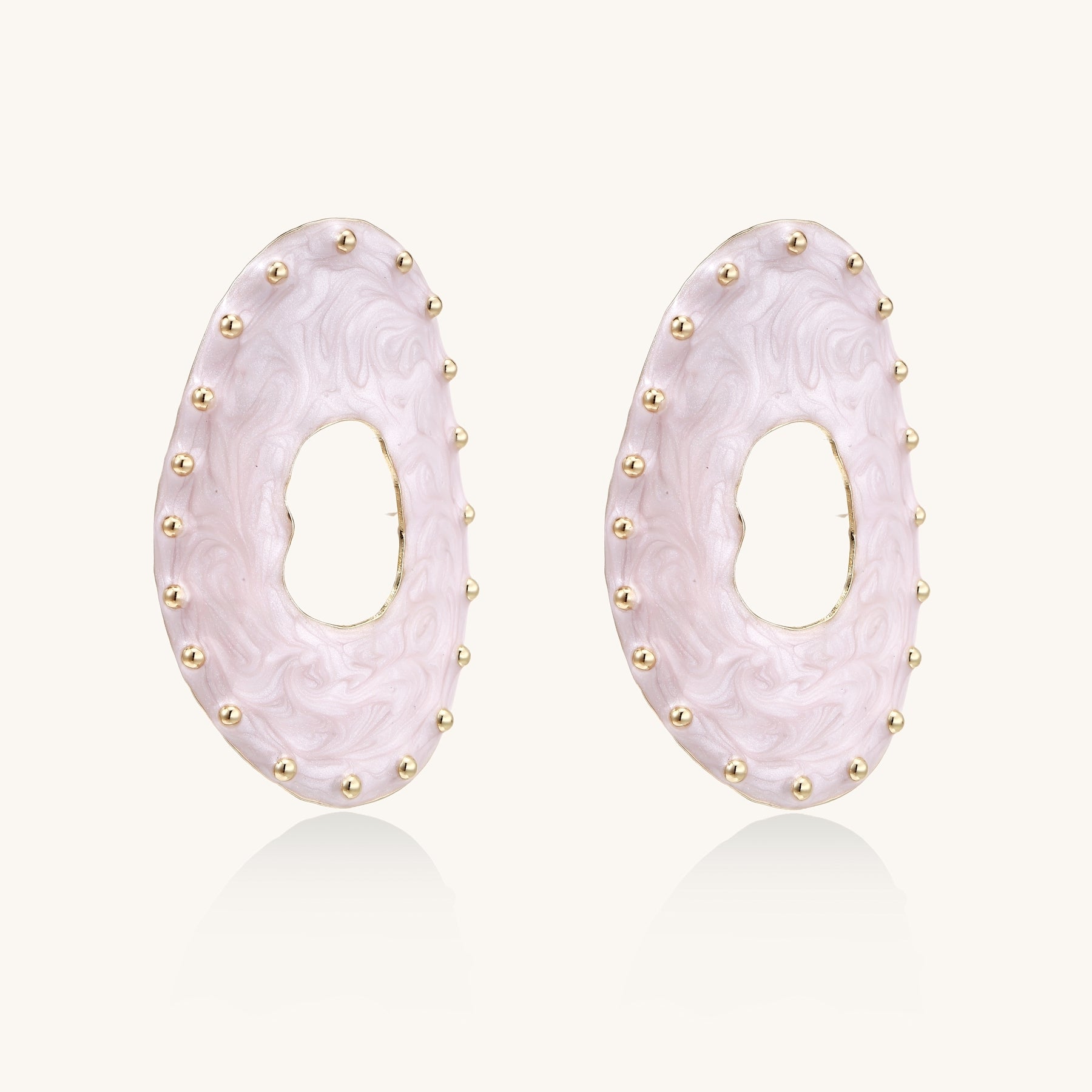 Oval lavender enamel earrings with gold studs around perimeter and cutout centers on white background