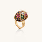 Domed gold-plated ring with geometric mosaic pattern featuring blue, green, red and clear zirconia stones in diamond settings