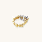 Bold gold-plated chain-link ring with cubic zirconia bars and sphere details on white background.